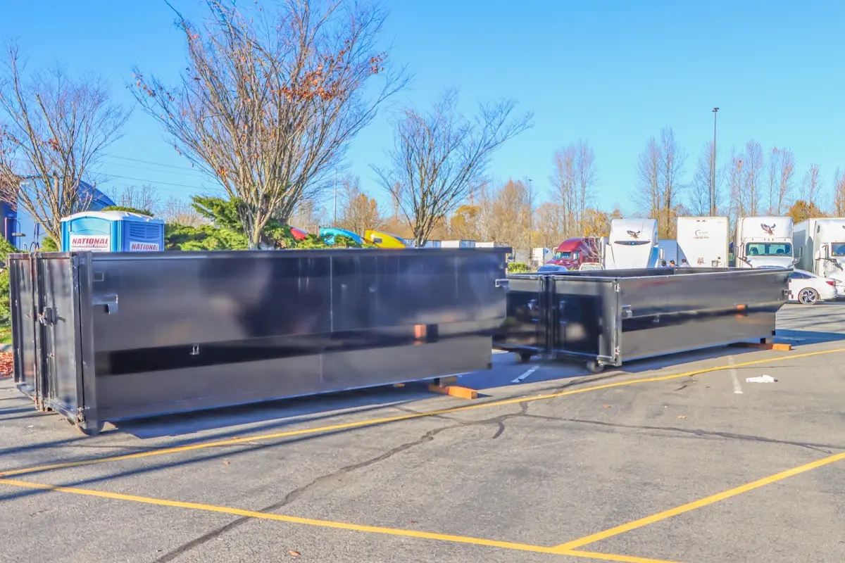 Professional dumpster rental service with roll-off container on residential driveway in Millstone